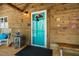 Cozy front porch with wooden walls, a blue door, rocking chair and farmhouse decor at 2281 Lamont Norwood, Pittsboro, NC 27312