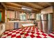 Charming kitchen featuring red and white checkered floors, stainless steel appliances, and ample cabinet space at 2281 Lamont Norwood, Pittsboro, NC 27312