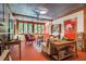 Inviting living room with warm decor, metal ceiling, and ample natural light from large windows at 2281 Lamont Norwood, Pittsboro, NC 27312