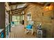 Inviting covered porch with wooden planks, cozy seating, and a view of the surrounding lush greenery at 2281 Lamont Norwood, Pittsboro, NC 27312