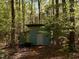 Outdoor shed nestled among trees, offering storage space at 2281 Lamont Norwood, Pittsboro, NC 27312