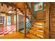 Bright staircase with wooden steps and blue railing adjacent to an open kitchen area at 2281 Lamont Norwood, Pittsboro, NC 27312