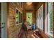 Bright sunroom featuring lots of natural light, wood paneling, and tile floor at 2281 Lamont Norwood, Pittsboro, NC 27312