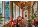 Bright sunroom featuring lots of natural light, wood paneling, and cozy seating area at 2281 Lamont Norwood, Pittsboro, NC 27312