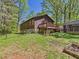 Spacious backyard featuring a wood deck, garden plot, and detached structure at 2419 George Anderson Dr, Hillsborough, NC 27278