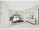 Cozy bedroom with a plush upholstered bed, side table and dresser, complete with stylish decor at 2419 George Anderson Dr, Hillsborough, NC 27278