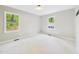 Bright bedroom featuring neutral walls, carpet, and natural light from the two windows at 2419 George Anderson Dr, Hillsborough, NC 27278