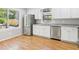 Well-lit kitchen featuring stainless steel appliances, granite countertops, and white cabinetry at 2419 George Anderson Dr, Hillsborough, NC 27278