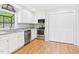 Well-maintained kitchen featuring stainless steel appliances, white cabinets, and laminate floors at 2419 George Anderson Dr, Hillsborough, NC 27278