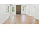 Bright living room featuring a brick fireplace, fresh white walls, and beautiful hardwood flooring at 2419 George Anderson Dr, Hillsborough, NC 27278