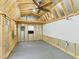 Interior view of the shed, featuring a ceiling fan, pegboard, and ample workspace at 2419 George Anderson Dr, Hillsborough, NC 27278