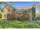 Exterior shot of a wooden deck and the back of the house with brick and shingle siding at 2510 Poplar Creek Rd, Henderson, NC 27537