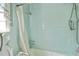 Tiled bathroom featuring a bathtub with shower, grab bars, and essential fixtures for accessibility and convenience at 2510 Poplar Creek Rd, Henderson, NC 27537