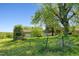 Detached two-car garage set amidst lush greenery with mature trees, offering both functionality and aesthetic appeal at 2510 Poplar Creek Rd, Henderson, NC 27537