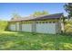 Detached multi-car garage with white doors, providing ample space for vehicles and storage at 2510 Poplar Creek Rd, Henderson, NC 27537