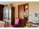 Interior shot of furniture, a doorway into the kitchen and a cabinet in a staged home at 2510 Poplar Creek Rd, Henderson, NC 27537