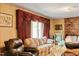 An interior view of a living room that features a fireplace, several sofas, and a window at 2510 Poplar Creek Rd, Henderson, NC 27537