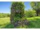 An ivy covered stone structure enhances the landscape, adding charm and character to this home's outdoor space at 2510 Poplar Creek Rd, Henderson, NC 27537