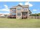 Wide, well-maintained backyard showcasing the home's deck, steps, and lush green lawn at 275 Sunrise Ridge Dr, Willow Springs, NC 27592