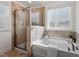 Bright bathroom featuring a glass shower and soaking tub at 275 Sunrise Ridge Dr, Willow Springs, NC 27592