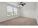 Carpeted bedroom featuring a ceiling fan and natural light from a large window at 275 Sunrise Ridge Dr, Willow Springs, NC 27592