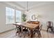 Bright and airy dining room with modern lighting and wood-style flooring, creating an inviting space at 275 Sunrise Ridge Dr, Willow Springs, NC 27592