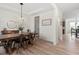 Modern dining room features a modern light fixture and wood-style floors, offering ample space for entertaining at 275 Sunrise Ridge Dr, Willow Springs, NC 27592