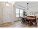 Bright dining area with natural light, modern light fixtures, and inviting wood-style flooring at 275 Sunrise Ridge Dr, Willow Springs, NC 27592