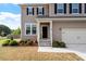 Close-up view of the home's front entrance, showing the front yard landscaping at 275 Sunrise Ridge Dr, Willow Springs, NC 27592