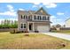 Beautiful two-story home features an attached two-car garage and a well-manicured lawn at 275 Sunrise Ridge Dr, Willow Springs, NC 27592