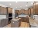 Well-lit kitchen with stainless steel appliances, granite countertops, and ample cabinet space at 275 Sunrise Ridge Dr, Willow Springs, NC 27592