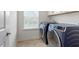 Well-equipped laundry room with new front-load washer and dryer units at 275 Sunrise Ridge Dr, Willow Springs, NC 27592