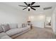 Cozy living room with plush gray sectional sofa and ceiling fan at 275 Sunrise Ridge Dr, Willow Springs, NC 27592
