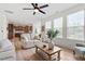 Bright living room boasts hardwood floors, large windows, and open access to the kitchen at 275 Sunrise Ridge Dr, Willow Springs, NC 27592