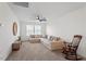 Spacious room features a sectional couch, wooden rocking chair, and ceiling fan at 275 Sunrise Ridge Dr, Willow Springs, NC 27592