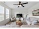 Bright and airy living room boasts ample natural light, a ceiling fan, and comfortable seating at 275 Sunrise Ridge Dr, Willow Springs, NC 27592