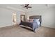 Bright main bedroom with gray upholstered headboard and ensuite bathroom at 275 Sunrise Ridge Dr, Willow Springs, NC 27592