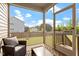 Cozy screened porch with comfortable seating, perfect for relaxing and enjoying the fresh air at 275 Sunrise Ridge Dr, Willow Springs, NC 27592