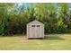 Charming backyard storage shed with neutral siding and a symmetrical design, nestled in a green lawn at 275 Sunrise Ridge Dr, Willow Springs, NC 27592