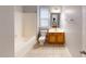 Cozy bathroom with a vanity, tiled floor, tub and shower combo and a window for natural light at 2750 Laurelcherry St, Raleigh, NC 27612