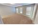Carpeted bedroom featuring neutral colors, multiple windows, and ample space at 2750 Laurelcherry St, Raleigh, NC 27612