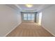 Bright bedroom features plush carpet, tray ceiling, and large windows at 2750 Laurelcherry St, Raleigh, NC 27612