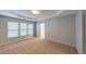 Expansive bedroom with tray ceiling, plush carpet, and ample natural light at 2750 Laurelcherry St, Raleigh, NC 27612