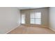 A carpeted bedroom provides access to the outside through a door and features a window for ample light at 2750 Laurelcherry St, Raleigh, NC 27612