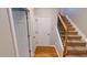 Inviting entryway featuring hardwood floors and a staircase with a wooden railing and iron balusters at 2750 Laurelcherry St, Raleigh, NC 27612