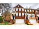 Brick townhome with attached garages, a covered entryway, and a stairway to the front door at 2750 Laurelcherry St, Raleigh, NC 27612