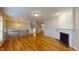 Bright living room featuring a fireplace, hardwood floors, and an open staircase at 2750 Laurelcherry St, Raleigh, NC 27612
