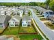 A high angle view of a fenced backyard in a neighborhood with manicured lawns and tree lined streets at 2901 Murray Ridge Trl, Apex, NC 27502