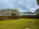 A spacious, fenced backyard featuring a lush lawn, perfect for outdoor activities and relaxation at 2901 Murray Ridge Trl, Apex, NC 27502