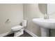 Elegant powder room featuring a pedestal sink, neutral paint, and contemporary fixtures at 2901 Murray Ridge Trl, Apex, NC 27502